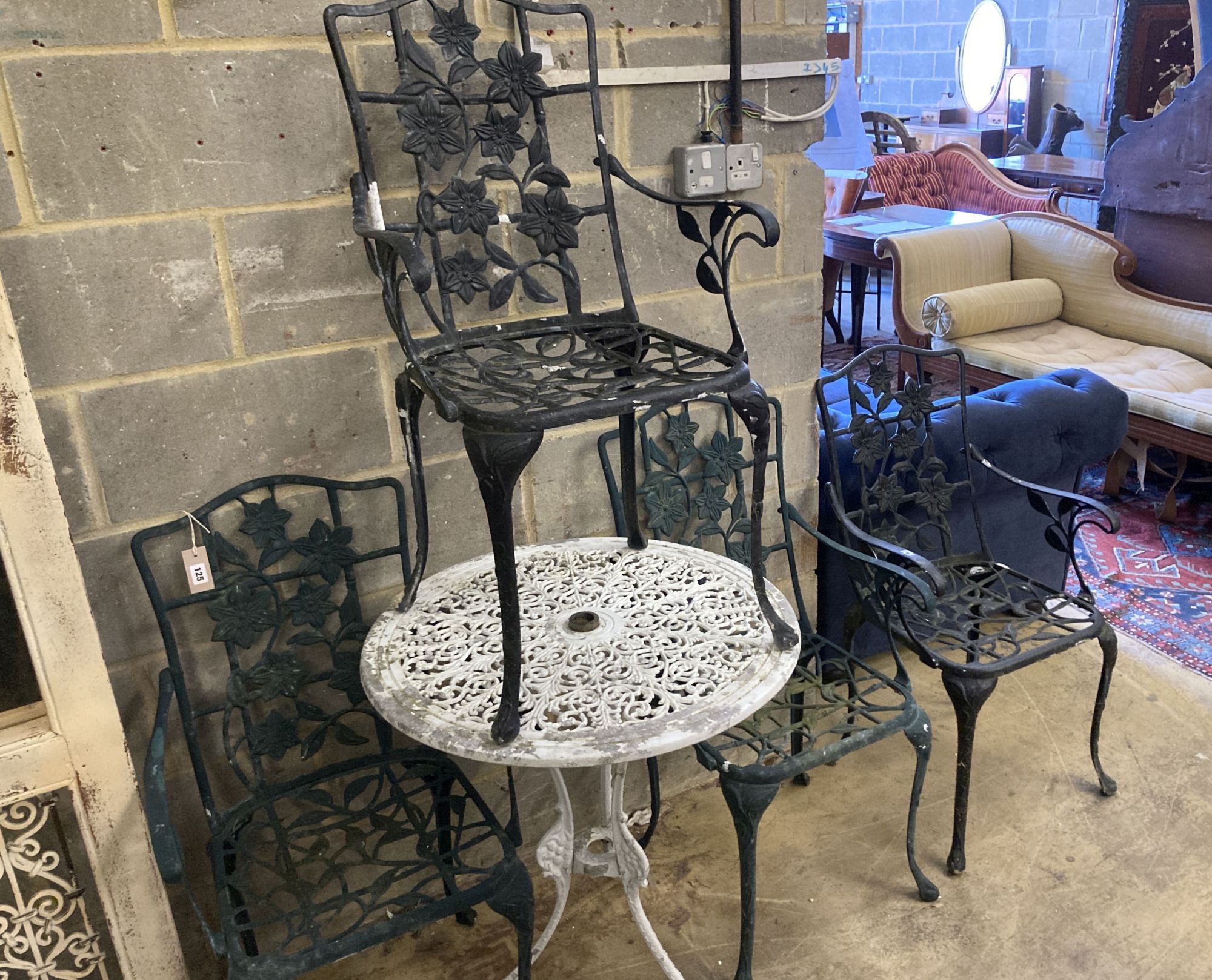 A Victorian style painted aluminium circular garden table, 69cm diameter together with a set of four garden elbow chairs